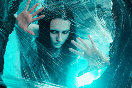 Woman sitting in big cocoon. Creative photoshootの写真素材