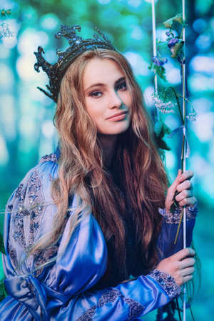 Princess in vintage dress walking in magic forest