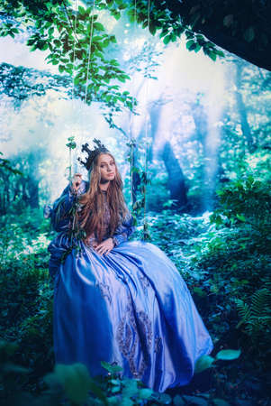 Princess in vintage dress walking in magic forest
