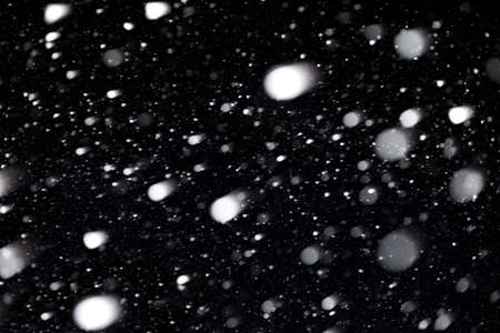 Real snow bokeh texture on black backgroundの写真素材