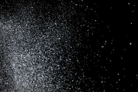 The falling snow on black background. Texture.の写真素材