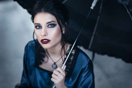 Woman in blue near old buildingの写真素材