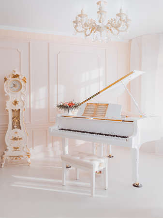 white grand piano standing in elegant interiorの写真素材
