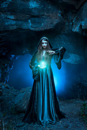 The witch with magic ball in her hands causes a spiritsの写真素材
