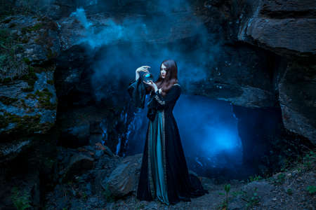 The witch with magic ball in her hands causes a spiritsの写真素材