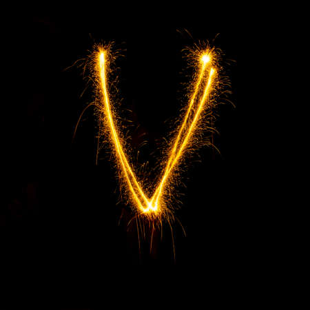 Alphabet sparklers on black background single letterの写真素材