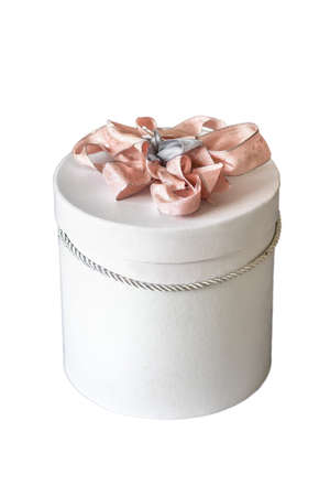 Gift box Tied with a pink ribbon close up on a white background.