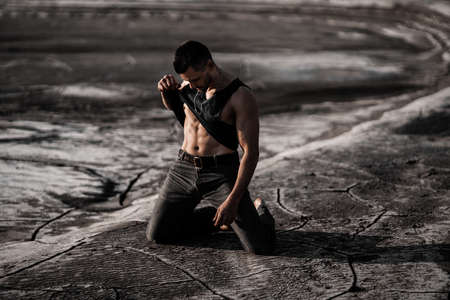 Attractive tanned man on the black sand