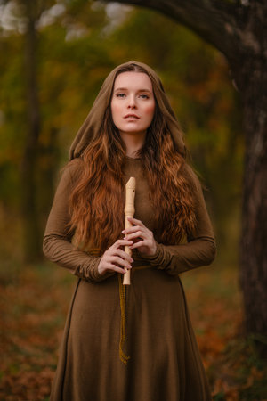 Redhead woman in dress walking in fantasy fairy tale forestの写真素材
