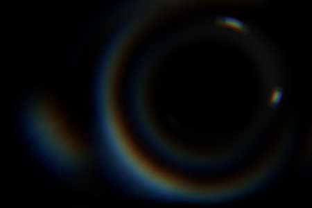 Abstract blurred colorful lens flare bokeh on black