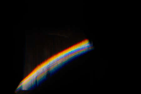 Abstract blurred colorful lens flare bokeh on black