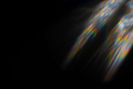 Abstract blurred colorful lens flare bokeh on black
