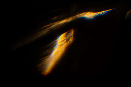 Abstract blurred colorful lens flare bokeh on black