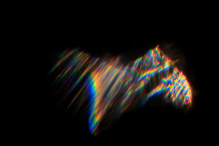 Abstract blurred colorful lens flare bokeh on black