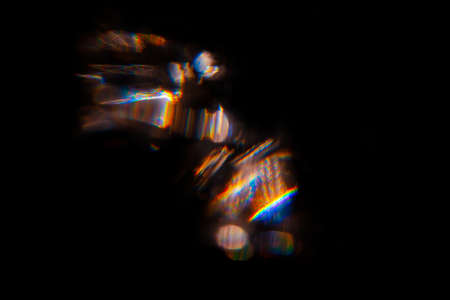 Abstract blurred colorful lens flare bokeh on black