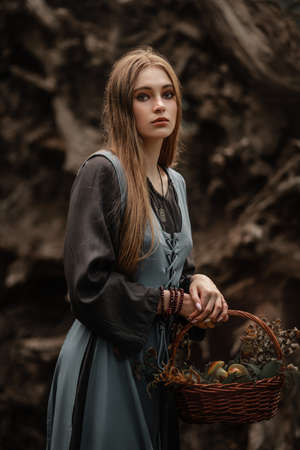 A mysterious witch walks in a dark forest