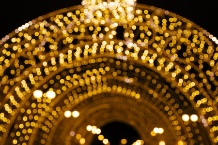 Golden holiday glowing backdrop. Defocused bokeh backgroundの写真素材