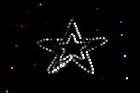 Golden holiday glowing backdrop. Defocused bokeh background