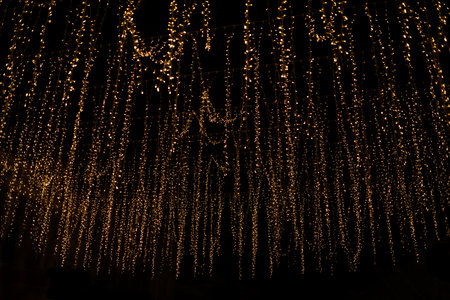 Gold abstract christmas bokeh on black backgroundの写真素材