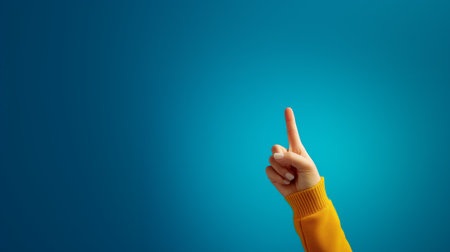 Hand gesture signaling importance against a blue backgroundの素材