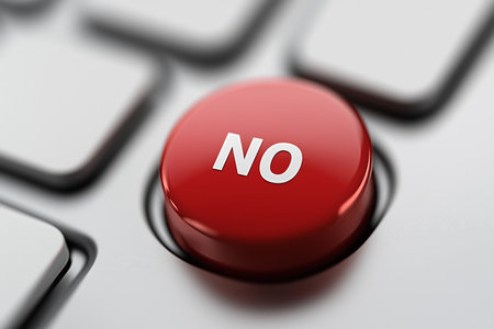 Red button with No for quick decision-making on a computer keyboard in an office settingの素材
