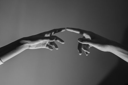 Close-up of a man and a woman hands gently touching, symbolizing connection, unity, and human relationships.の写真素材