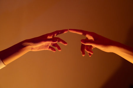 Close-up of a man and a woman hands gently touching, symbolizing connection, unity, and human relationships.の写真素材