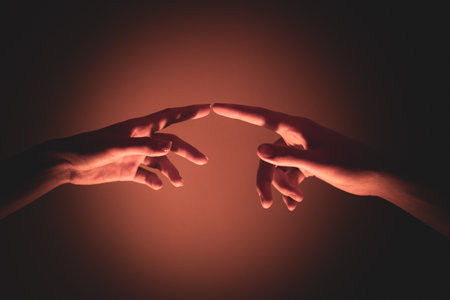 Close-up of a man and a woman hands gently touching, symbolizing connection, unity, and human relationships.の写真素材