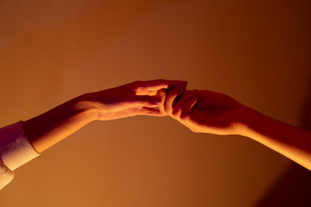Close-up of a man and a woman hands gently touching, symbolizing connection, unity, and human relationships.の写真素材