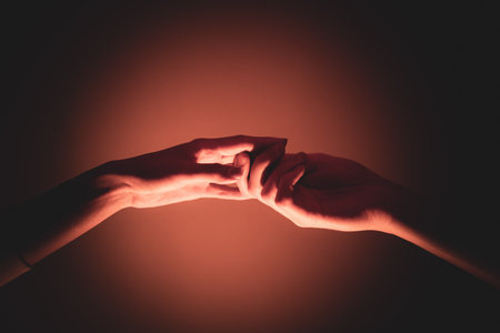 Close-up of a man and a woman hands gently touching, symbolizing connection, unity, and human...