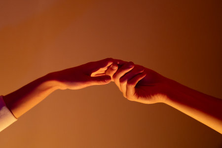 Close-up of a man and a woman hands gently touching, symbolizing connection, unity, and human...