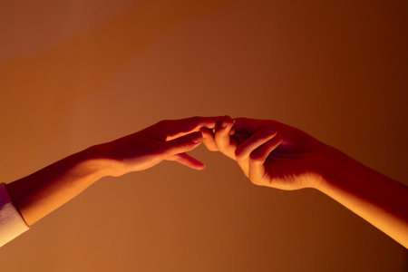 Close-up of a man and a woman hands gently touching, symbolizing connection, unity, and human relationships.の写真素材