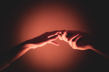Close-up of a man and a woman hands gently touching, symbolizing connection, unity, and human relationships.の写真素材