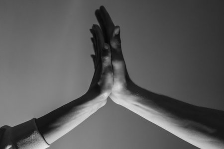 Close-up of a man and a woman hands gently touching, symbolizing connection, unity, and human relationships.の写真素材