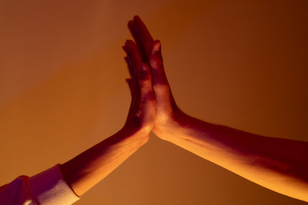 Close-up of a man and a woman hands gently touching, symbolizing connection, unity, and human...