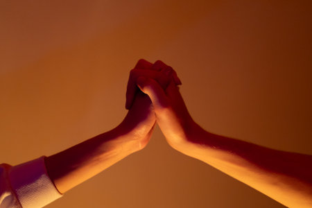 Close-up of a man and a woman hands gently touching, symbolizing connection, unity, and human relationships.の写真素材