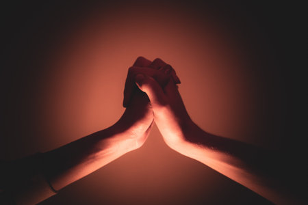 Close-up of a man and a woman hands gently touching, symbolizing connection, unity, and human relationships.の写真素材