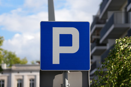 A blue parking sign displayed in an outdoor setting, indicating a designated parking zone.の写真素材