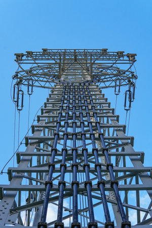 High-voltage transmission pole where electrical wires shift from overhead lines to underground...