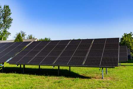 Ground-mounted solar panels absorbing sunlight in a solar farm, clean energy concept, renewable energy, sustainable technology.の写真素材