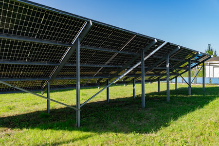 Ground-mounted solar panels absorbing sunlight in a solar farm, clean energy concept, renewable...