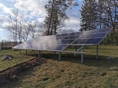 Ground-mounted solar panels absorbing sunlight in a solar farm, clean energy concept, renewable...