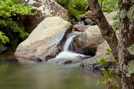 small waterfall on a river paradise.の写真素材