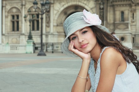 Beautiful young woman in a fashion pose in a Parisian plazaの写真素材