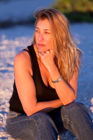 Pretty Middle Age Blond Woman at the Beach in the late afternoon.の写真素材