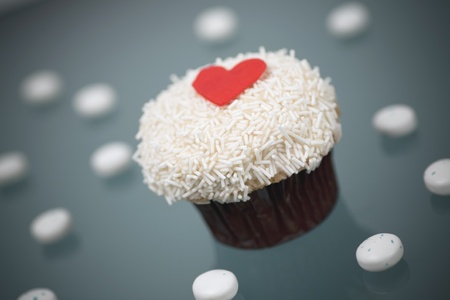 Gourmet Vanilla Buttercream Cupcake on a gray background with candiesの写真素材