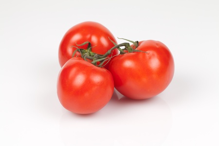 Ripe vine tomatoes on a white backgroundの写真素材