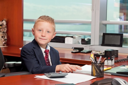 Cute Young Boy in Business Officeの写真素材