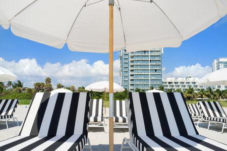 Colorful lounge chairs and umbrellas in Miami South Beachのeditorial素材