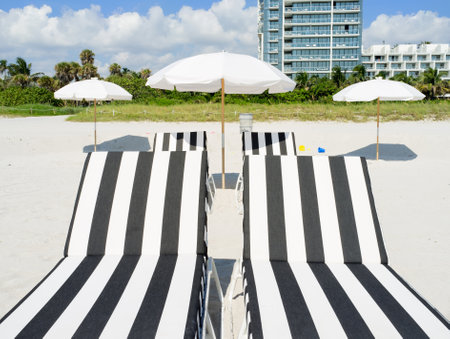 Colorful lounge chairs and umbrellas in Miami South Beachのeditorial素材